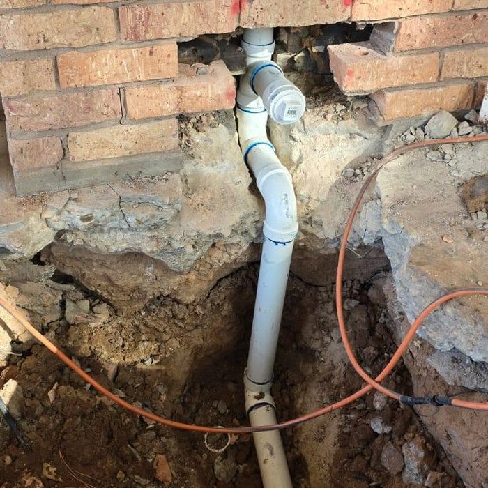 Drain line and plumbing repair beneath foundation
