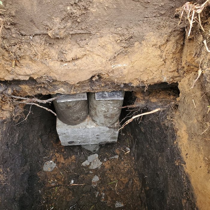 Pier installation beneath foundation, close-up