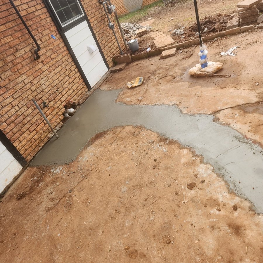 Fresh concrete patio poured behind a Houston home